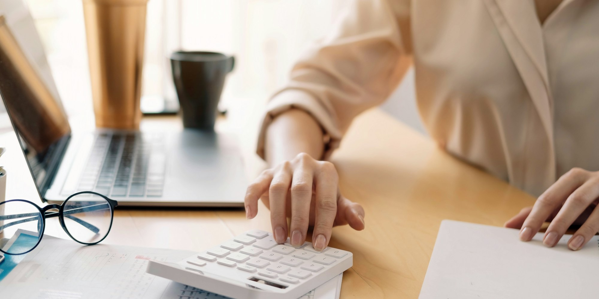 Close up view of bookkeeper or financial inspector hands making report, calculating or checking