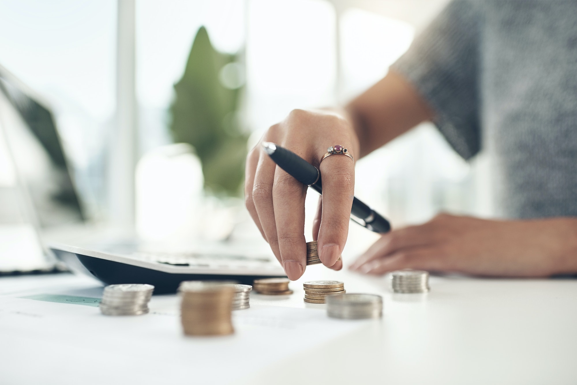 Closeup shot of an unrecognisable businesswoman calculating finances in an office